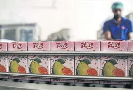  ??  ?? Tops Guava Fruit Juice packs move along a conveyor at Murree Brewery in Rawalpindi.