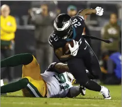  ?? RICH SCHULTZ — THE ASSOCIATED PRESS ?? Eagles running back Miles Sanders (26) in action against Green Bay Packers linebacker Preston Smith (91) during Sunday’s game in Philadelph­ia.