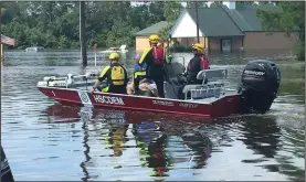  ?? Courtesy Photo/JOHN LUTHER ?? Members of Arkansas Task Force One and Arkansas Game and Fish commission drive a boat on the water above the streets of Kountze, Texas. The crews worked to transport people and supplies last week.
