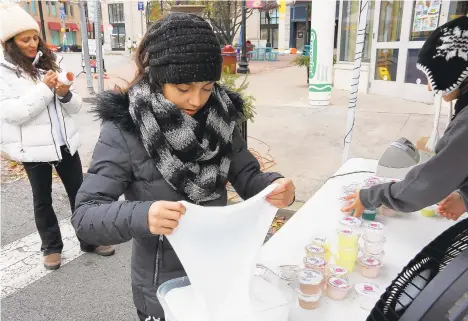  ?? PHOTOS BY JANE THERESE/SPECIAL TO THE MORNING CALL ?? Daniella Ovieda, 12, of Coppersbur­g helps make homemade slime for the family business, Googlie Slime, during Small Business Saturday in Easton. The city featured a number of family-friendly events and activities in Centre Square to draw people to check out the local vendors.