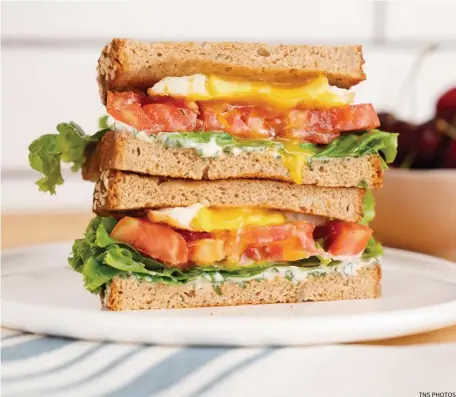  ?? Tns pHOtOs ?? TWIST ON A CLASSIC: ELT sandwiches feature fried eggs and basil mayonnaise.
