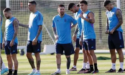  ?? ?? Lionel Messi talks with his Argentina teammate Paulo Dybala during a training session in Doha on Monday. Photograph: Rungroj Yongrit/ EPA