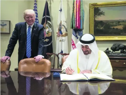  ?? Ryan Carter / Crown Prince Court – Abu Dhabi ?? Sheikh Mohammed bin Zayed, Crown Prince of Abu Dhabi and Deputy Supreme Commander of the Armed Forces, signs the guest book in the White House at the start of his meeting with Donald Trump.