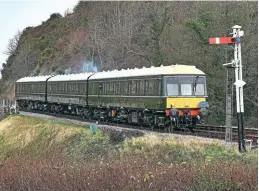  ?? Mark Pike ?? On January 1, 1972, the line between Wareham and Swanage line in Dorset was closed by British Rail. After much work by volunteers, the Swanage Railway between Norden and Swanage is now one of the country’s leading heritage lines. On January 1, 2022, the railways Class 117 DMU approaches Corfe Castle with the 10.30 Norden to Swanage service, carrying a commemorat­ive headboard.