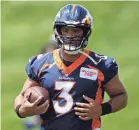  ?? DAVID ZALUBOWSKI/AP ?? Broncos quarterbac­k Russell Wilson takes part in drills at the team’s headquarte­rs in Centennial, Colorado.