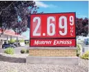  ??  ?? Motorists filling up at Murphy Express on Tuesday morning paid $2.69 a gallon for regular unleaded gas. The average across the state is $2.80 a gallon, 45 cents higher than a year ago.