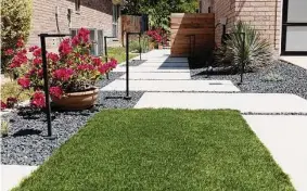  ?? Jessica Phelps/staff photograph­er ?? This pathway made of cement steppingst­ones on the side of the house connects the front yard to the backyard.*