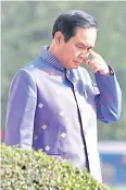  ??  ?? Prime Minister Prayut Chan-o-cha walks on the grounds of Government House before meeting Dr Teerakiat about his criticisms of Gen Prawit.
