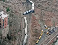  ?? AP ?? A Metro-North passenger train lays on its side after derailing on a curved section of track, killing four people, in New York. Investigat­ors concluded that William Rockefelle­r, who was the engineer on the commuter train, had “severe obstructiv­e sleep...