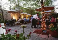  ?? Shannon O'Hara ?? Outdoor dining, such as on the patio at Hugo’s, has no occupancy limits but must abide by socialdist­ancing rules. Patrons have shown they’re willing to tolerate our climate to dine out.