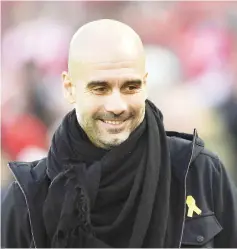  ?? — AFP photo ?? In this file photo taken on January 14, 2018 Manchester City's Spanish manager Pep Guardiola arrives for the English Premier League football match between Liverpool and Manchester City at Anfield in Liverpool, north west England.