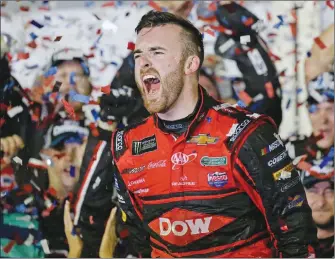  ??  ?? Austin Dillon celebrates in Victory Lane after winning Sunday’s Daytona 500 Cup race at Daytona Internatio­nal Speedway in Daytona Beach, Fla.
Austin Dillon, center, celebrates with his crew as they dive on the grass in the infield after winning...