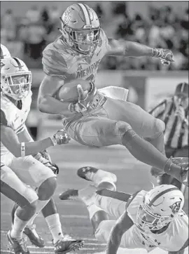  ?? Mark Weber Associated Press ?? MEMPHIS running back Patrick Taylor Jr. sails out of bounds. Memphis had five straight touchdown drives and 410 yards rushing in a 59-22 victory.