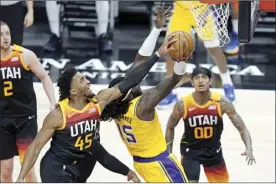  ?? AP photo ?? Jazz guard Donovan Mitchell blocks a shot by Lakers center Montrezl Harrell during the first half of Utah’s 114-89 victory over Los Angeles on Wednesday.