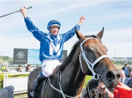  ?? Photo / Getty Images ?? Hugh Bowman celebrates after Winx became the first Australian horse to win 30 consecutiv­e races.