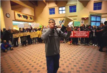  ?? ADOLPHE PIERRE-LOUIS/JOURNAL ?? Shakir Farid Abdullah uses a megaphone to speak to the hundreds of protesters who took over the arrival and departure area at Albuquerqu­e’s Sunport on Sunday.