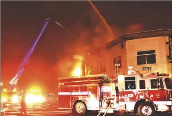  ?? PHOTO TOM BODUS ?? More than 30 firefighte­rs from six department­s assisted in combatting the Mayan Hotel fire.