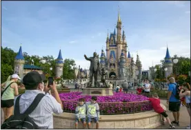  ?? TED SHAFFREY — THE ASSOCIATED PRESS FILE ?? People visit the Magic Kingdom Park at Walt Disney World Resort in Lake Buena Vista, Fla., on April 18.