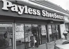  ?? Mark Ralston / Getty Images ?? Customers leave a Payless store in Los Angeles after the company announced it will close all 2,100 of its U.S. locations.