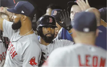  ?? AP PHOTO ?? GOOD FINISH: Jackie Bradley Jr. (above) gets a high five in the dugout after scoring on a wild pitch in the top of the 11th inning; Matt Barnes (left) nailed down the 1-0 victory in the bottom of the inning.