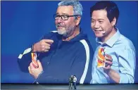  ?? FENG YONGBIN / CHINA DAILY ?? Lei Jun (right), CEO of Xiaomi, presents the full-screen Mi Mix2 with its French designer, Philippe Starck, at a new product launch event in Beijing on Sept 11.