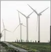  ??  ?? A wind farm produces electricit­y in Weatherfor­d, Okla. The cost of wind and solar plants has been plummeting.