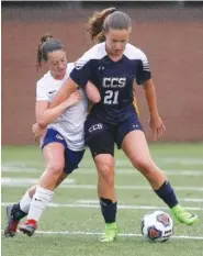  ?? STAFF PHOTOS BY C.B. SCHMELTER ?? Boyd-Buchanan’s Sydney Miller challenges Chattanoog­a Christian’s Kate Dirkse (21) at Boyd-Buchanan’s David L. Boyd Field on Tuesday. CCS won 5-0.