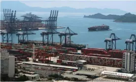  ?? Photograph: Martin Pollard/Reuters ?? A cargo ship carrying containers is seen near the Yantian port in Shenzhen following the Covid-19 outbreak in Guangdong province.