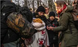  ?? Photograph: Alessio Mamo/The Guardian ?? Volunteer Anna Alboth (right) helping people who have crossed the border into Poland from Belarus.