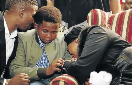  ?? PHOTOS: ROGAN WARD ?? S’fiso Ncwane’s son Ngcweti and wife Ayanda could not control their grief at the singer’s memorial service in Durban yesterday.