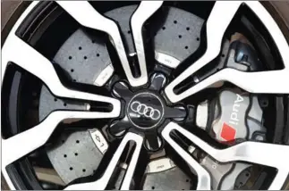  ?? CHRISTOF STACHE/AFP ?? The logo of the German car producer Audi on a wheel of a car displayed at Audi’s annual general meeting in Neckarsulm, Germany, on May 18. Authoritie­s in German say they have arrested an executive in connection with the company’s emissions-cheating...