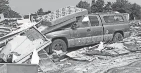  ?? PHOTOS BY CHRIS LANDSBERGE­R/ THE OKLAHOMAN FILE ?? Storm damage is evident and debris is left behind at the Skyview Mobile Home Park after a tornado in El Reno. The EF3 tornado killed two people and injuring many others.