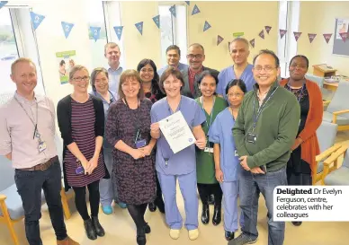  ??  ?? Delighted Dr Evelyn Ferguson, centre, celebrates with her colleagues