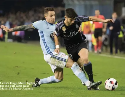  ??  ?? Celta's Hugo Mallo fights for the ball with Real Madrid's Marco Asensio