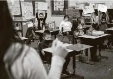  ??  ?? Third-graders raise their answers for teacher Yadira Sesher at Calder Road Elementary in Dickinson.