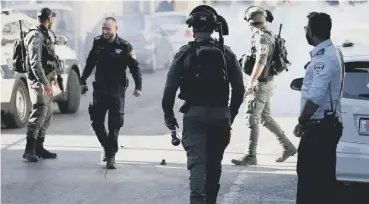  ??  ?? 0 Israeli security officers fire stun grenades during a protest after Muna al-kurd’s arrest