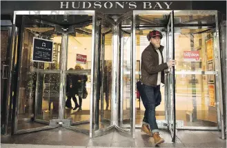  ??  ?? A man leaves the Hudson’s Bay Company store in Toronto on Wednesday. HBC said it has received an offer from European retail competitor SIGNA Holding for its German department store chain Kaufhof and other real estate assets.