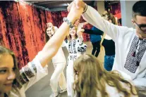  ?? WOJCIECH GRZEDZINSK­I/THE WASHINGTON POST ?? Ukrainian dancing marks a night of fun for students in Kyiv. The war has forever changed the lives of many of the country’s young.