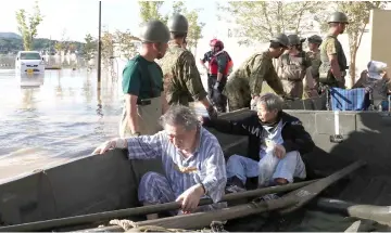  ??  ?? People are rescued by Self-Defense Forces personnel from Mabi Memorial Hospital that was isolated due to flood damage caused by heavy rain in Kurashiki, Okayama prefecture. — AFP photo