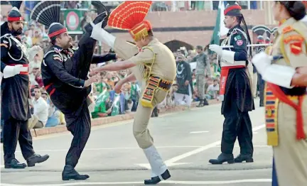  ??  ?? Show of force on the Wagah border: Nuclear-armed neighbours India and Pakistan have fought three wars. AFP