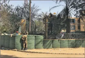  ?? AP/LUDIVINE LANIEPCE ?? Security forces guard the armed forces general staff building Saturday in Ouagadougo­u, Burkina Faso, in the wake of Islamic extremist attacks last week.