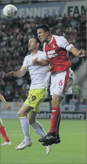  ??  ?? Hull City’s Will Keane and Rotherham United’s Richard Wood battle for the ball in their Championsh­ip meeting at the AESSEAL New York Stadium.