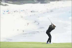  ?? Warren Little / Getty Images ?? Brooks Koepka of the United States plays his second shot on the ninth hole during a practice round for the U.S. Open at Pebble Beach Golf Links on Monday in California.