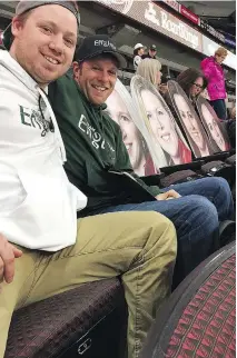  ?? KEN WARREN ?? Jordan Hogan, left, and Brandy Westcott have helped fill a few of the empty seats at Canadian Tire Centre, plopping down larger-than-life cardboard cut-outs of Englot team members.