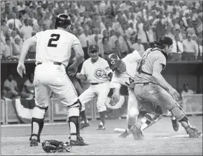  ?? THE ASSOCIATED PRESS ?? In this July 14, 1970, file photo, National League’s Pete Rose slams into American League catcher Ray Fosse to score the winning run during the 12th inning of the baseball All-Star Game in Cincinnati. Looking on are third base coach Leo Durocher, and on-deck batter Dick Dietz (2). Fosse, the strong-armed catcher whose career was upended when he was bowled over by Rose in the All-Star Game, has died. He was 74. Carol Fosse, his wife of 51 years, said in a statement Fosse died Wednesday, Oct. 13, 2021, after a 16-year bout with cancer.