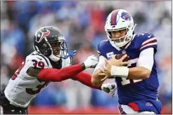  ?? Adrian Kraus — The Associated Press ?? Buffalo Bills quarterbac­k Josh Allen, right, runs past Houston Texans cornerback Terrance Mitchell during the first half of an NFL football game, Sunday, Oct. 3, 2021, in Orchard Park, N.Y.