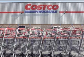  ?? Mario Tama / Getty Images ?? Shopping carts are lined up in front of a Costco store on Thursday in Inglewood, Calif. Costco announced plans to increase its minimum wage to $16 per hour.