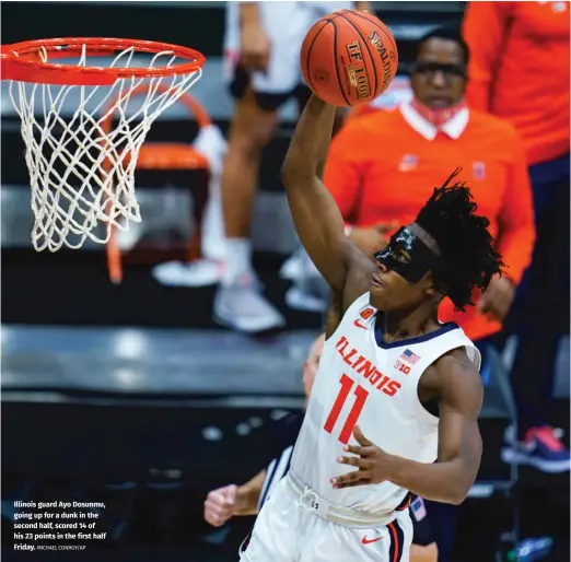  ?? MICHAEL CONROY/AP ?? Illinois guard Ayo Dosunmu, going up for a dunk in the second half, scored 14 of his 23 points in the first half Friday.