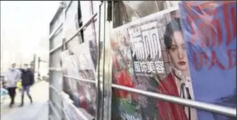  ??  ?? Chinese actress Zheng Shuang is seen on a cover of a fashion magazine at a newsstand in Beijing, China, January 20, 2021. (Reuters photo)