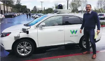  ??  ?? Windsor-native Christophe­r Shulgan stands beside a Waymo self-driving Lexus at Google X, the search company’s so-called moonshot factory that pioneered self-driving cars, in Mountain View, Calif.